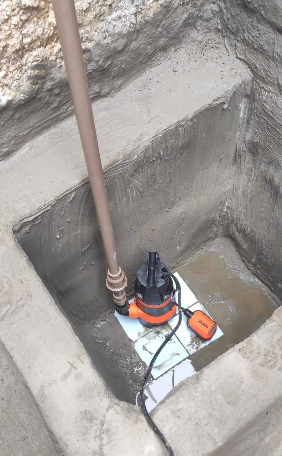 Bomba instalada em reservatório de concreto
